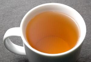 A cup of tea with a light golden color