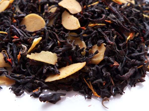 Loose-leaf black tea with whole slices of almond and red-orange safflower petals