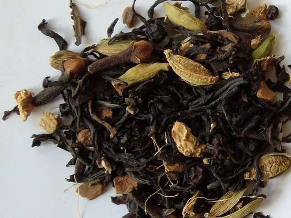 Blend of black tea leaves with green cardamom pods, cloves, and some other dried chunks of spices